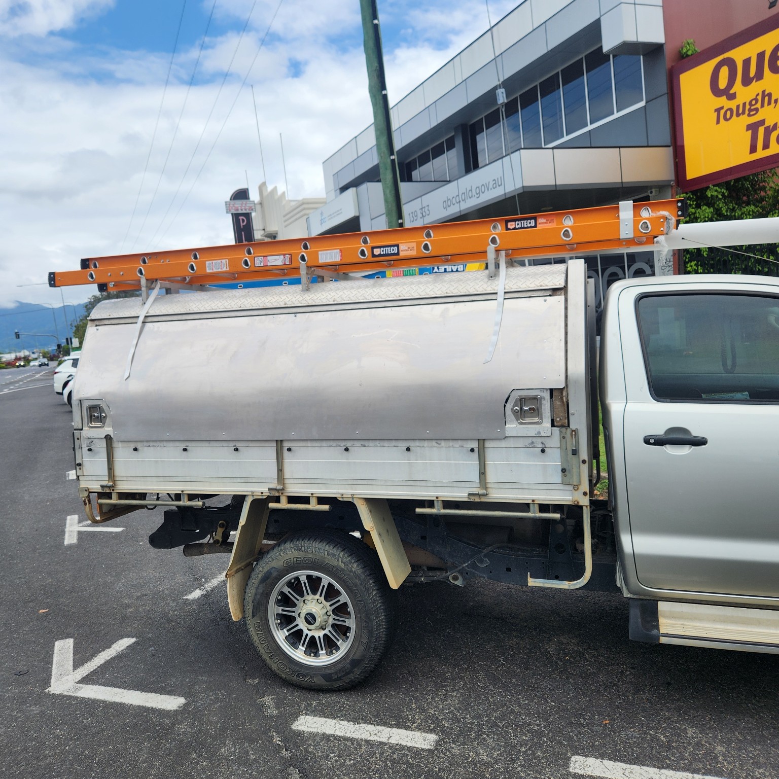 Andrew's Solls Electrical work ute with tools and ladders in Cairns